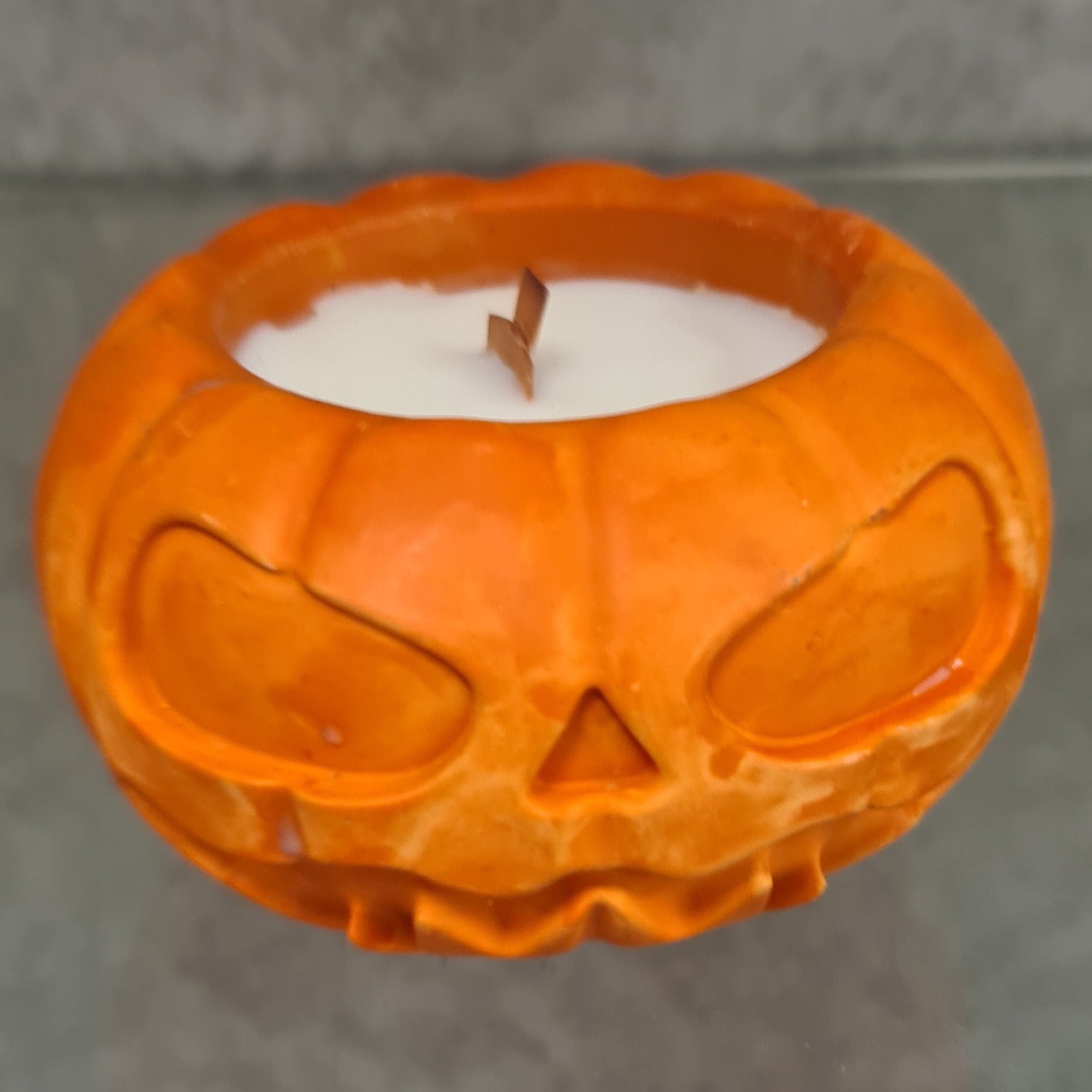 Harvest Bliss Scented Pumpkin Candle with enchanting autumn aroma, eco-friendly natural wax, and festive Halloween design.