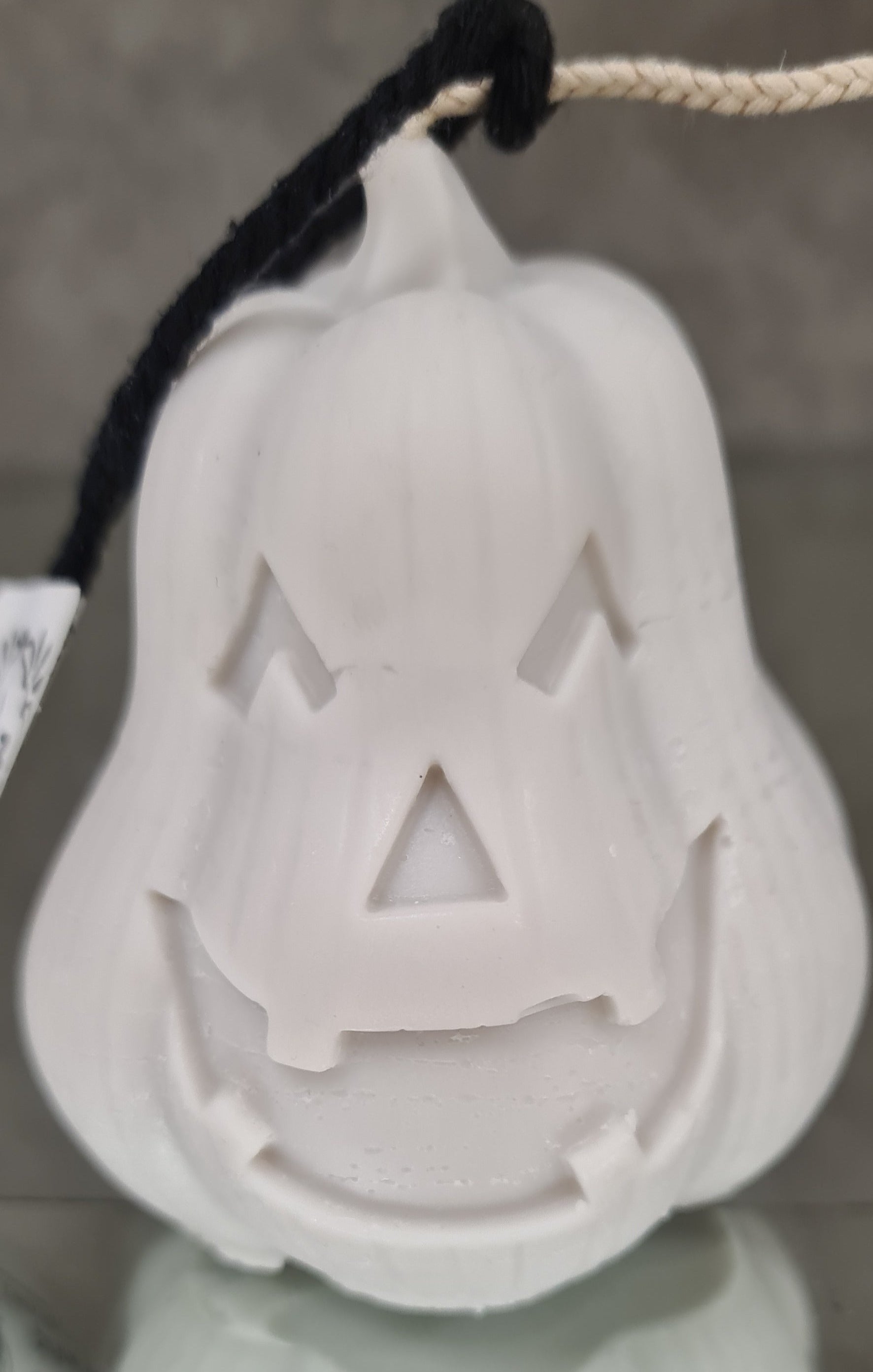 Close-up view of Pumpkin Enchantment Scented Candle, a whimsical pumpkin-shaped candle with a warm, flickering flame